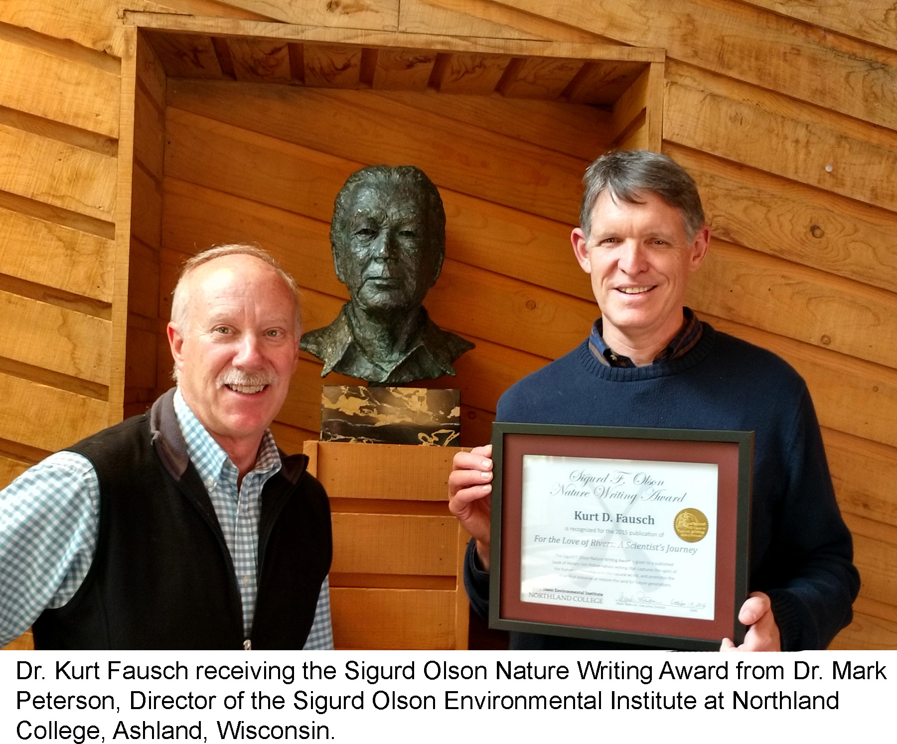Dr. Kurt Fausch receiving the Sigurd Olson Nature Writing Award from Dr. Mark Peterson, Director of the Sigurd Olson Environmental Institute at Northland College, Ashland, Wisconsin